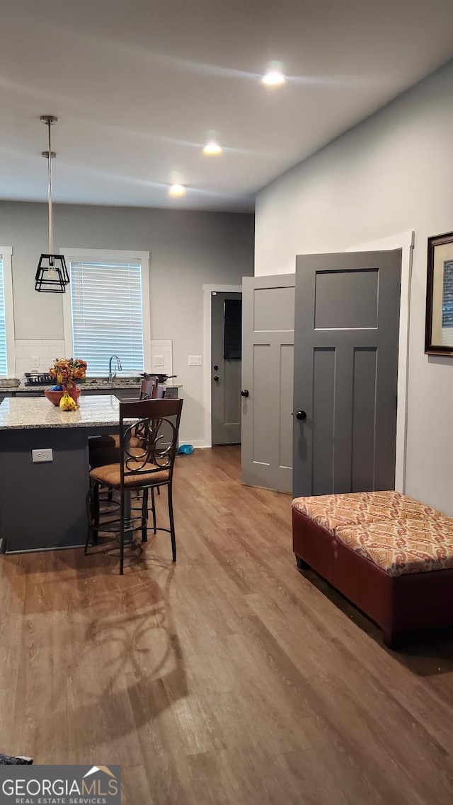 dining space with plenty of natural light, sink, and hardwood / wood-style floors