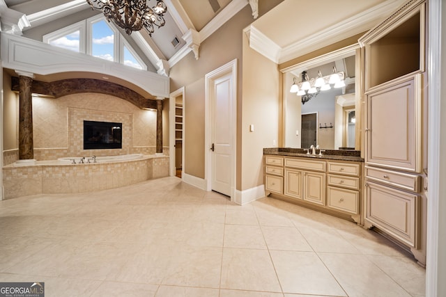 bathroom featuring an inviting chandelier, crown molding, high vaulted ceiling, vanity, and tiled bath