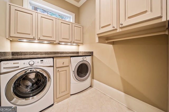 laundry area featuring ornamental molding, cabinets, and washing machine and clothes dryer