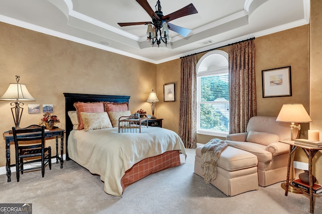 carpeted bedroom with crown molding, ceiling fan, and a tray ceiling