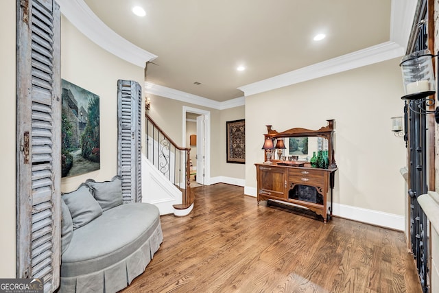 foyer entrance with wood-type flooring and ornamental molding