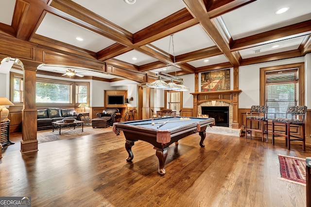 game room with decorative columns, coffered ceiling, a wealth of natural light, and a fireplace