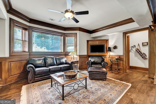 living room with crown molding, ceiling fan, and dark hardwood / wood-style floors