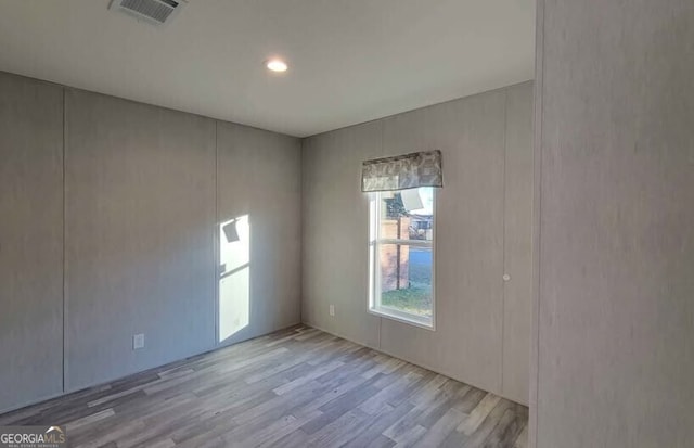 spare room with light hardwood / wood-style flooring