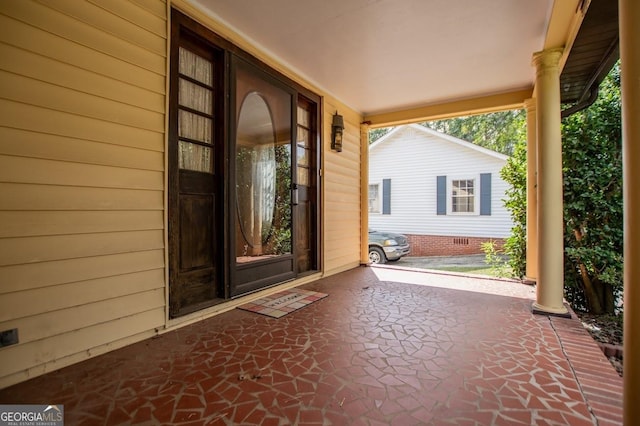 view of exterior entry with a porch