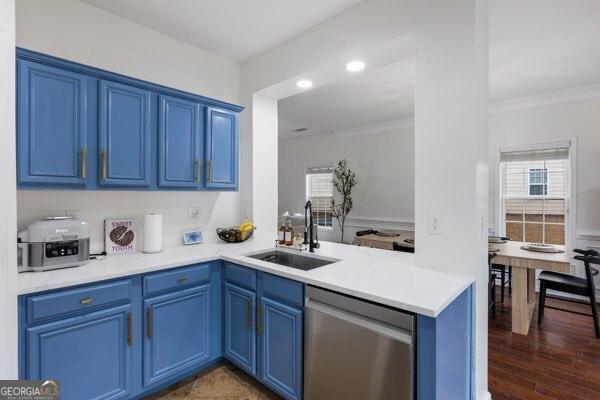 kitchen featuring blue cabinets, dishwasher, sink, and crown molding