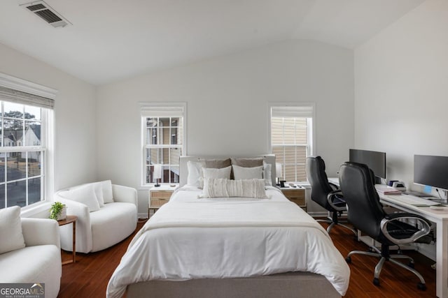 bedroom with dark wood-type flooring, vaulted ceiling, and multiple windows