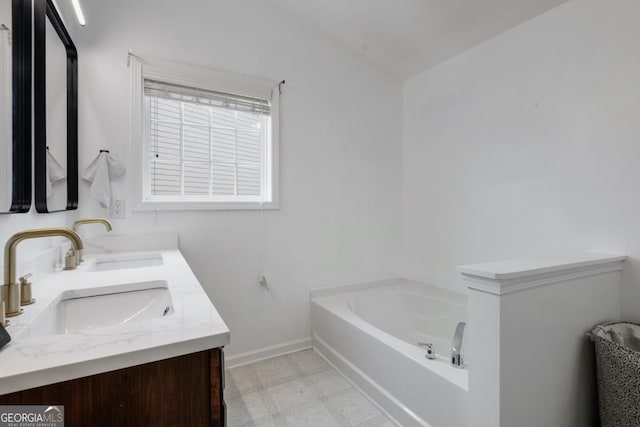 bathroom with vanity and a tub