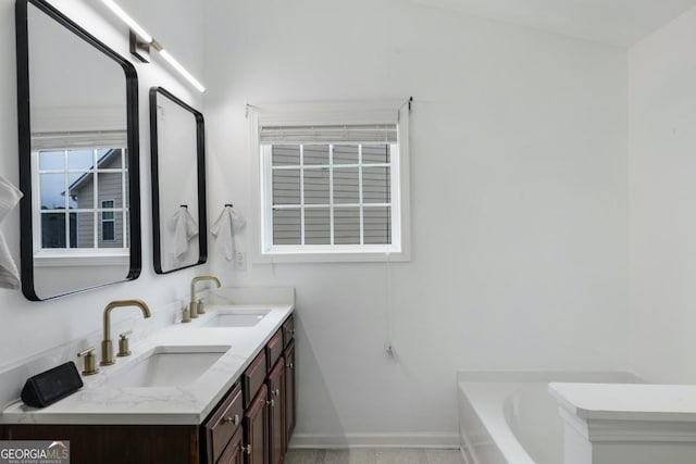 bathroom featuring vanity and a tub to relax in