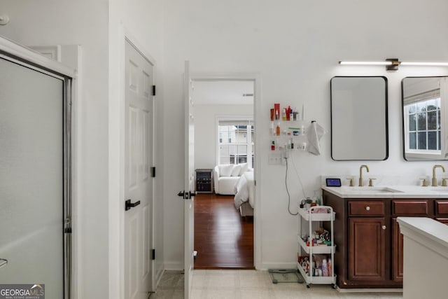 bathroom with walk in shower and vanity