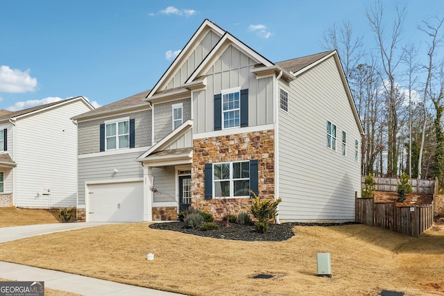 craftsman-style home with an attached garage, fence, stone siding, concrete driveway, and board and batten siding