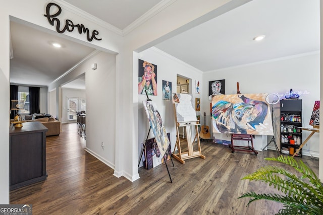 interior space with baseboards, ornamental molding, and wood finished floors