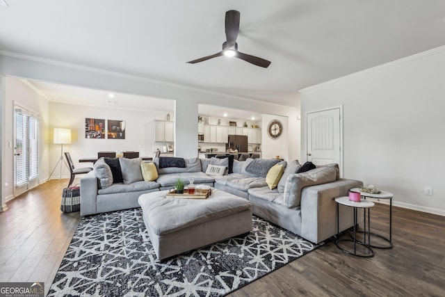 living room featuring ornamental molding, dark wood-type flooring, and ceiling fan