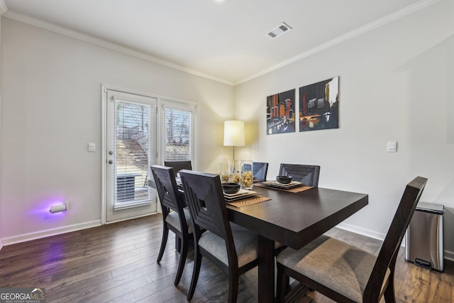 dining space featuring dark hardwood / wood-style flooring and ornamental molding