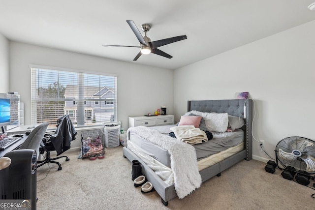 bedroom with a ceiling fan, carpet flooring, and baseboards