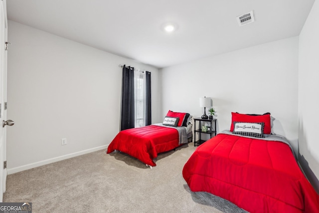 carpeted bedroom featuring baseboards and visible vents