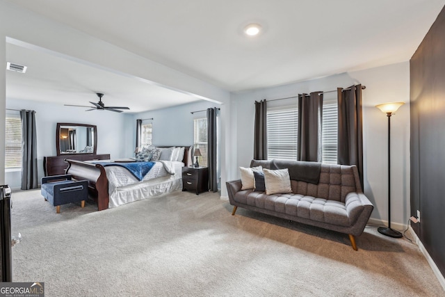 bedroom featuring visible vents, ceiling fan, light carpet, and baseboards