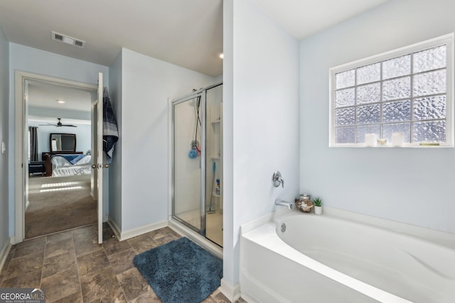 full bath featuring a stall shower, baseboards, visible vents, a garden tub, and stone finish flooring