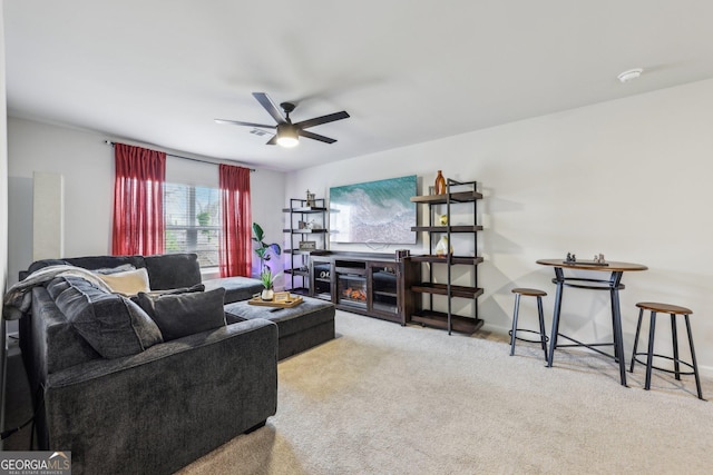 carpeted living room featuring ceiling fan