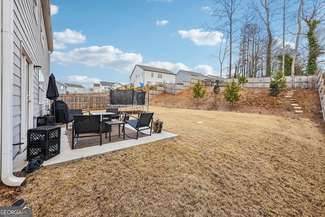 view of yard featuring a patio and a trampoline