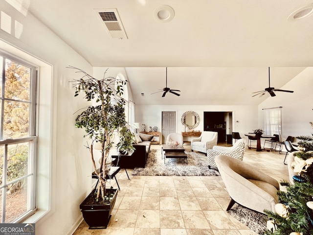 living room featuring vaulted ceiling and ceiling fan