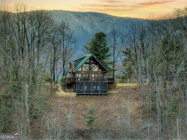 back house at dusk with a mountain view