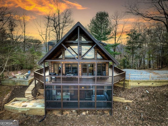 view of back house at dusk