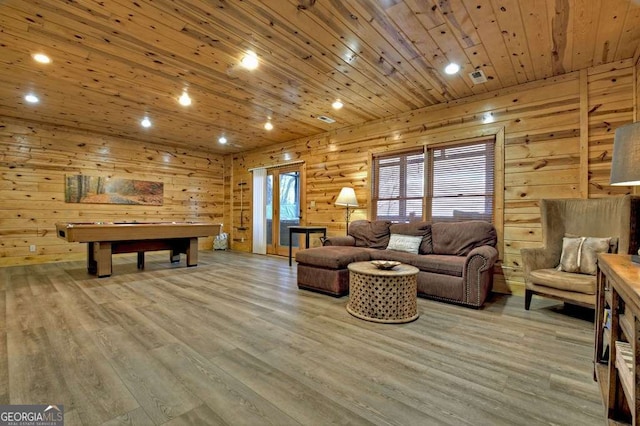 living room featuring wood ceiling, wood walls, and light wood-type flooring