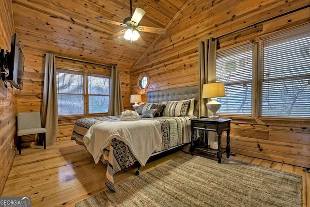 bedroom featuring wooden ceiling, lofted ceiling, light hardwood / wood-style flooring, and wood walls