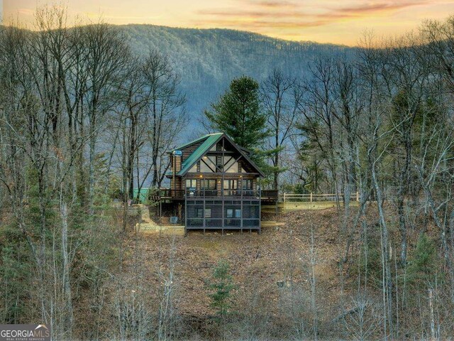 view of back house at dusk