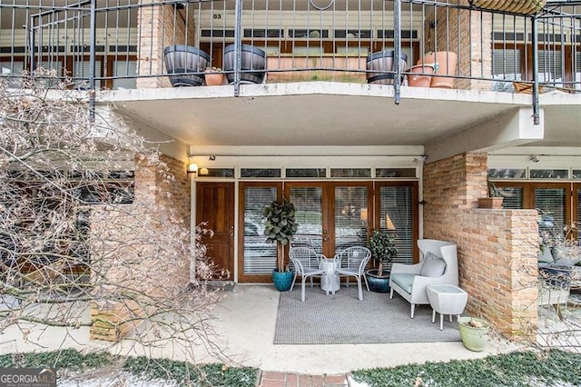 property entrance with a patio and a balcony