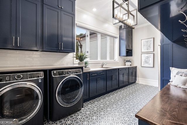 laundry room featuring separate washer and dryer, sink, ornamental molding, and cabinets