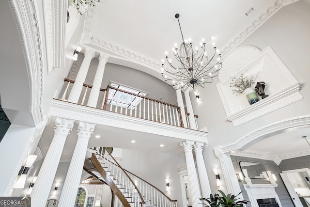 interior space with decorative columns and a towering ceiling