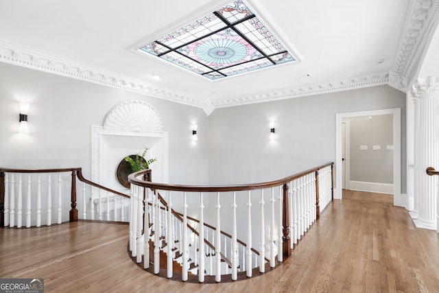 hall with ornamental molding and hardwood / wood-style floors