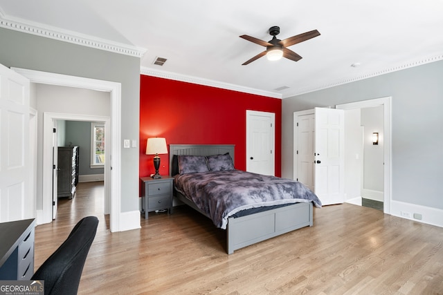 bedroom with crown molding, ceiling fan, and light wood-type flooring