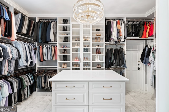 walk in closet with an inviting chandelier