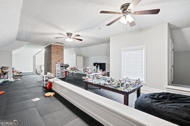 carpeted bedroom featuring ceiling fan, vaulted ceiling, and a textured ceiling