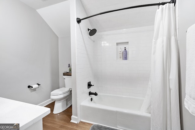 bathroom with shower / tub combo, wood-type flooring, lofted ceiling, and toilet