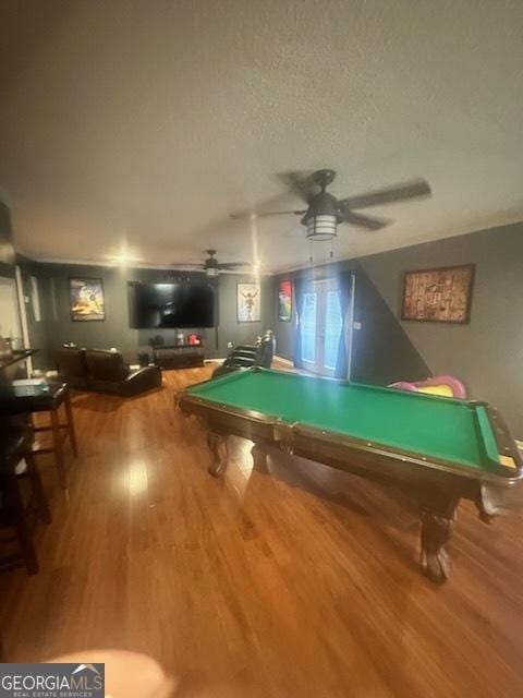 rec room featuring ceiling fan, billiards, hardwood / wood-style floors, and a textured ceiling