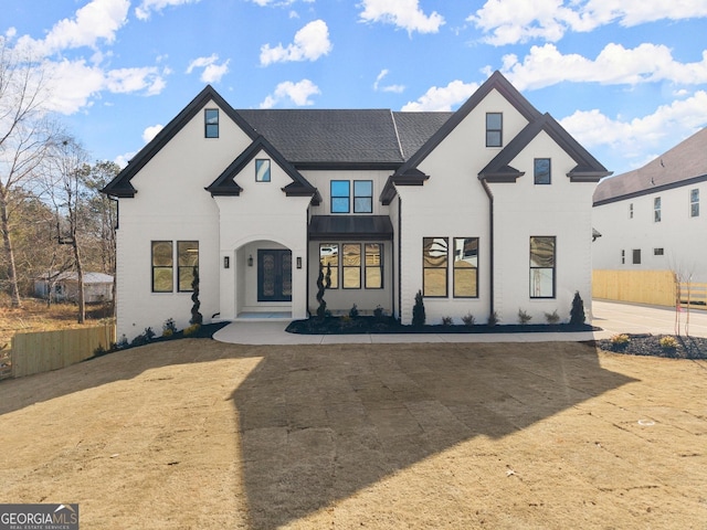 1041 Fleeman Rd, Hoschton, GA 30548 - view of front of home featuring a shingled roof, fence, and stucco siding