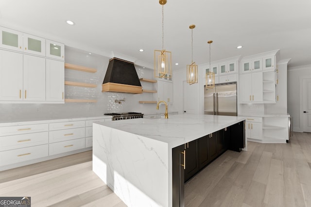 kitchen with a spacious island, custom exhaust hood, tasteful backsplash, stainless steel built in fridge, and white cabinets