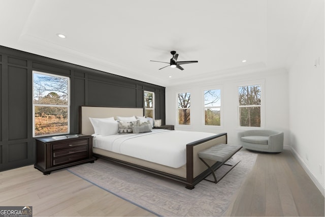 1041 Fleeman Rd, Hoschton, GA 30548 - bedroom featuring light wood-type flooring, a tray ceiling, recessed lighting, ceiling fan, and baseboards