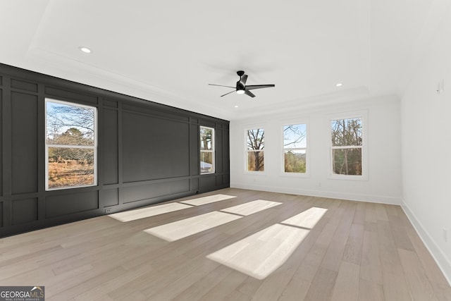 1041 Fleeman Rd, Hoschton, GA 30548 - unfurnished room with healthy amount of natural light, a tray ceiling, recessed lighting, a ceiling fan, and light wood-type flooring