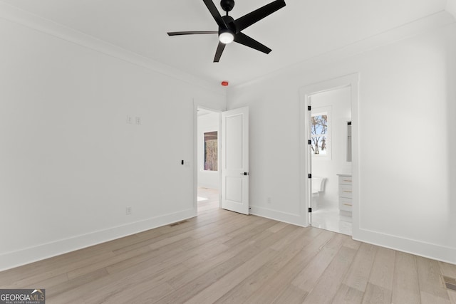 unfurnished bedroom featuring crown molding, light hardwood / wood-style floors, ceiling fan, and ensuite bathroom