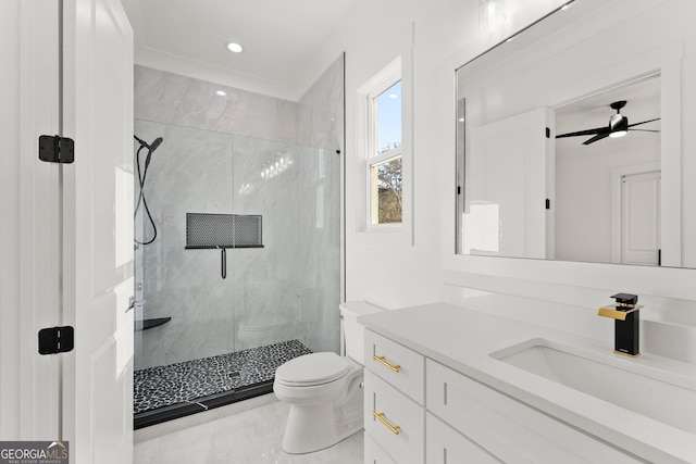 bathroom with ceiling fan, vanity, toilet, and an enclosed shower