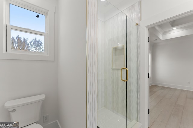 bathroom with an enclosed shower, hardwood / wood-style floors, and toilet