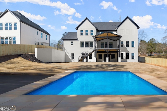 1041 Fleeman Rd, Hoschton, GA 30548 - swimming pool featuring stairway, a fenced backyard, and a patio