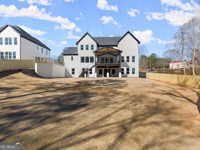 1041 Fleeman Rd, Hoschton, GA 30548 - back of property featuring stairway, fence, and a deck