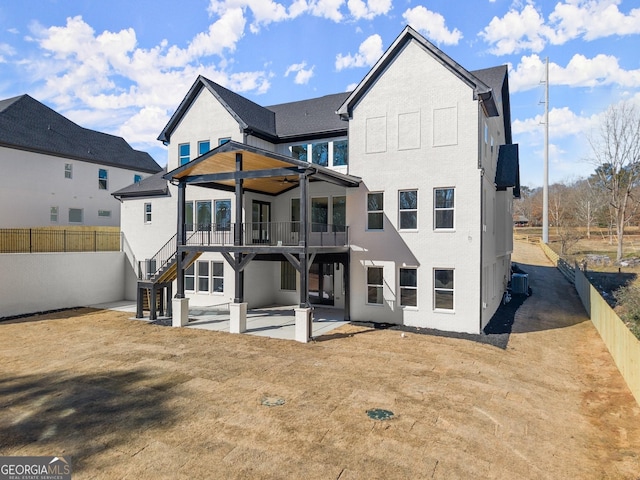 back of property featuring cooling unit, ceiling fan, and a patio