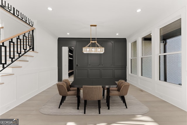 1041 Fleeman Rd, Hoschton, GA 30548 - dining area with a decorative wall, light wood-type flooring, a chandelier, recessed lighting, and stairs